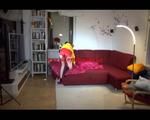 Lucy preparing her sofa with a shiny nylon cloth wearing a sexy red/yellow shiny nylon shorts and a yellow rain jackcet (Video)