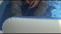 Pia ties and gagges herself in a small swimming pool wearing sexy grey rainwear (Video)