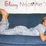 Katharina wearing a supersexy grey shiny nylon rainwear catsuit while lolling on the sofa (Pics)