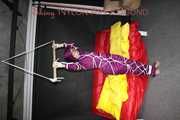 Watching sexy Sonja wearing a supersexy purple shiny nylon rainwear combination being tied and gagged overhead with ropes and a clothgag (Pics)