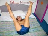 Katharina posing in a hotel bed wearing only a sexy oldschool darkblue/lightblue shiny nylon shorts (Pics)
