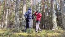 Sebastien breathplay tied up in a puffer jacket among the trees.
