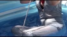 Pia ties and gagges herself in a small swimming pool wearing sexy grey rainwear (Video)