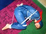 one of our archive girls tied and gagged in a shiny nylon rainsuit