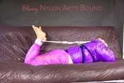 *** HOT HOT HOT*** NEW MODELL*** SANDRA wearing a sexy transparent purple shiny nylon pants and a purple down jacket tied and gagged on a sofa with ropes hand to feet and a cloth gag (Pics)