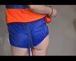 Mara wearing a sexy shiny swimsuit and a shiny nylon shorts trying on a lifevest (Video)