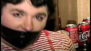 25 Yr OLD 2nd GRADE SCHOOL TEACHER IS MUMMY WRAPPED AND GAGGED WITH PLASTIC WRAP, BLACK ELECTRICAL TAPE AND SILVER DUCT TAPE ON A CHAIR (D68-13)