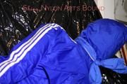 Mara tied, gagged and hooded on a black covered sofa wearing a super hot pink rain pants and a blue rain Jacket (Pics)