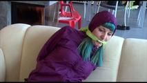 Mara tied and gagged on a sofa wearing a shiny purple rainwear combination (Video) 
