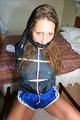 Stella tied and gagged on a chair wearing a blue shiny nylon shorts and a rain jacket (Pics)