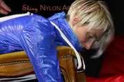 Watching sexy Sonja wearing a sexy shiny nylon shorts in blue and a blue rain jacket being tied and gagged on a stool with ropes and a clothgag (Pics)