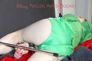 ***HOT HOT HOT*** LUCY tied and gagged on a bed with a bar and a cloth gag wearing sexy green shiny nylon shorts and a green rain jacket (Pics)