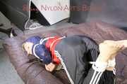 SANDRA tied, gagged and hooded with ropes on a bed wearing a supersexy oldschool rain jacket and a shiny nylon rain pants (Pics)