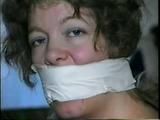 25 YR OLD CHARLENE IS WRAP GAGGED & CHAIR TIED TO A CHAIR WITH WHITE CLOTH MEDICAL TAPE (D47-14)