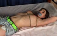 Tapegagged topless barefoot Bianca in jeans shorts, tied on the bed with her legs wide-spread, wiggles helplessly