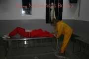 Watching Stella being tied and gagged with ropes and a ballgag on a operating table from Leonie both wearing sexy shiny nylon rainwear (Pics)