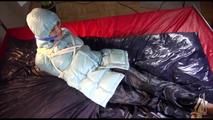 Lulu tied and gagged on a bed wearing a sexy blue shiny nylon rainpants and a iceblue PAMY downjacket (Video)