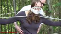 Mitzi tied up between 2 trees