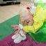 Beautiful archive girl tied and gagged on a blow-up arm chair wearing a sexy yellow shiny nylon shorts and a rain jacket (Pics)