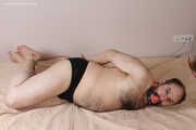 Amanda undresses and ties a man into hogtie and gag him