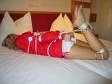 Beautiful archive girl tied and gagged on a bed wearing shiny shorts (Pics)