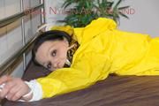 Lucy tied and gagged on bedposts face-down position wearing a sexy yellow shiny nylon shorts and a yellow rain jacket (Pics)