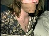 28 YEAR OLD HOUSEWIFE IS MOUTH STUFFED, WRAP TAPE GAGGED, TOE-TIED,  BLINDFOLDED, and HOG-TIED (D57-14)