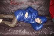 Sexy Sonja changing clothes to a brown down pants and a blue down jacket and lolling on the sofa (Pics)