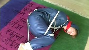 01:00 Min. video with an archive girl tied and gagged in shiny nylon rainwear