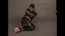 4 short videos in one of an beautiful black haired archive girl tied and gagged on the floor wearing sexy shiny nylon rainwear (Video)