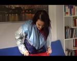 Jill folding shiny nylon clothes wearing shiny nylon clothes (Video) 