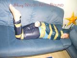 Leoni tied, gagged and hooded with tape wearing a sexy blue rainwear combination (Pics)