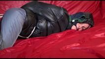 Sonja tied, gagged and hooded on bed wearing a sexy grey rain pants and black down jacket (Video)