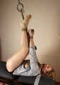 Ballgagged barefoot Albina Rose, balltied on the massage couch, wiggles helplessly