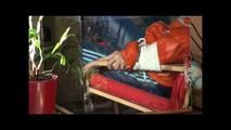 Pia tied and gagged on a chair wearing a shiny orange downjacket (Video)