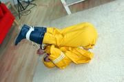 Katharina tied and gagged in a yellow rainsuit