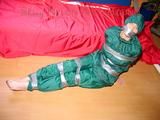 Jill tied, gagged and hooded on a sofa with tape wearing supersexy shiny nylon oldschool rainwear (Pics)