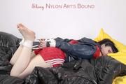 Jill tied and gagged on a bed wearing red shiny nylon shorts(Pics)