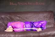 *** HOT HOT HOT*** NEW MODELL*** SANDRA wearing a sexy transparent purple shiny nylon pants and a purple down jacket tied and gagged on a sofa with ropes hand to feet and a cloth gag (Pics)