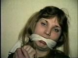 26 Yr OLD BARMAID IS WRISTS GAGGED, BAREFOOT, FEET TIED, HANDGAGGED, MOUTH STUFFED, & CLEAVE GAGGED (D52-15)