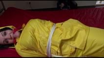 Jill tied, gagged and hooded on a bed wearing wonderful shiny yellow rainwear (Video)