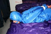 Alina tied and gagged in a shiny skisuit
