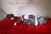 ***NEW MODEL*** Sandra wearing highheels and a sexy red crazy sensation skibib as well as a grey down jacket tied and gagged on a sofa with tape (Pics)