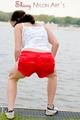 Enni having a good time outdoor wearing sexy shiny nylon shorts and a top posing for the camera (Pics)