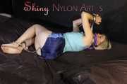 Sonja  being tied and gagged with cuffs and a clothgag on a bed wearing a sexy shiny nylon shorts and a top (Pics)