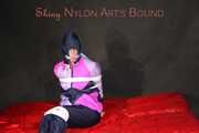 Watching Pia wearing blue/pink shiny nylon rainwear being tied and gagged and hooded with tape and a clothgag (Pics)