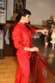 Jill posing in a bar wearing a sexy red rainwear combination with nothing under it (Pics)