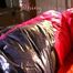 Mara in bed wearing supersexy pink shiny nylon downjacket with hood and a rain pants (Pics)