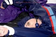 Jill tied and gagged in shiny nylon rainware