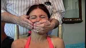34 YEAR OLD HOTEL MANAGER IS CLEAVE GAGGED, TAPE GAGGED, HANDGAGGED, MOUTH STUFFED, OTM DOUBLE GAGGED, GAG TALKING, BAREFOOT, TOE-TIED WHILE TIGHTLY TIED TO A CHAIR (D73-18)